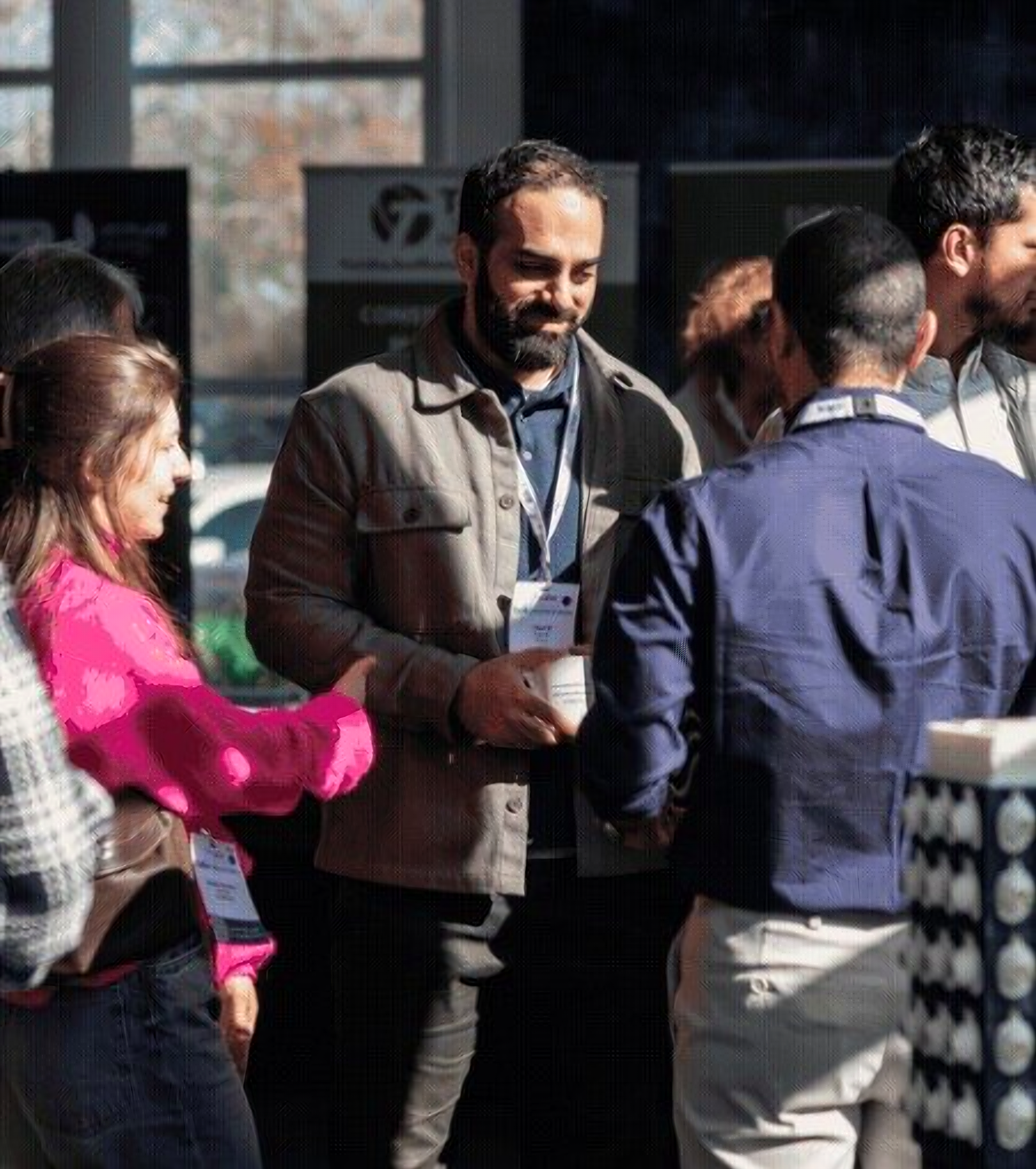 Mohammad Afsari talking with others at an event